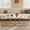 Side view of the large coffee table from the nesting set, featuring a faux marble top and sturdy gold metal frame.