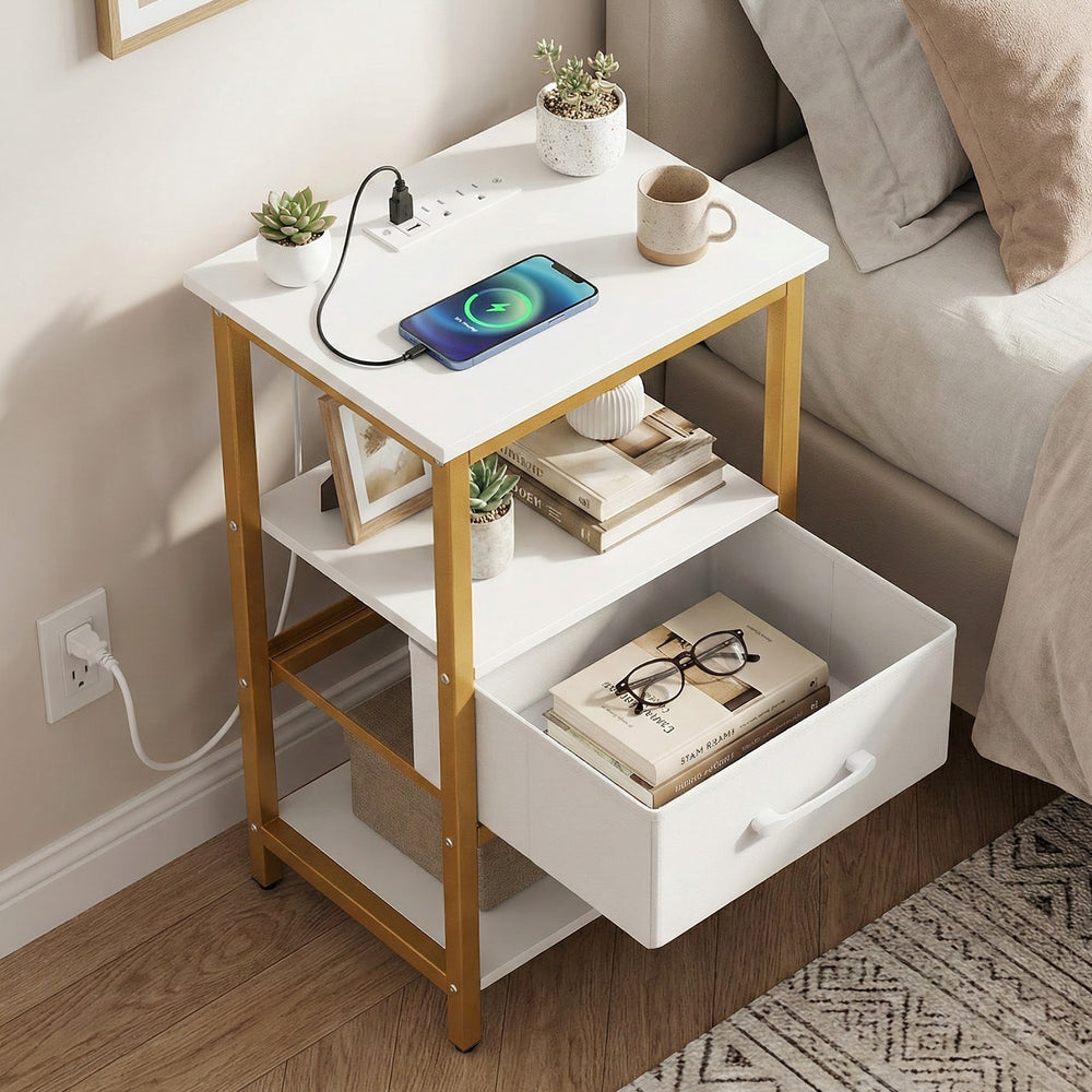Nightstand with charging station in white and gold, featuring open shelves and an adjustable fabric drawer for.