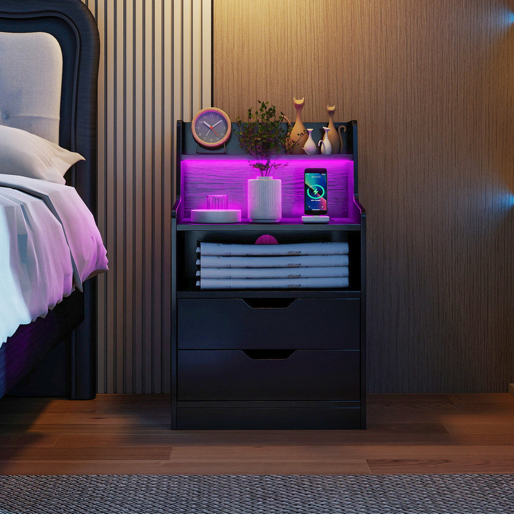 Black nightstand with adjustable RGB LED light, charging station, and ample storage for bedroom organization.