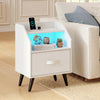 Nightstand in white with LED lights, fabric drawer, and open shelf for organized storage and device charging.