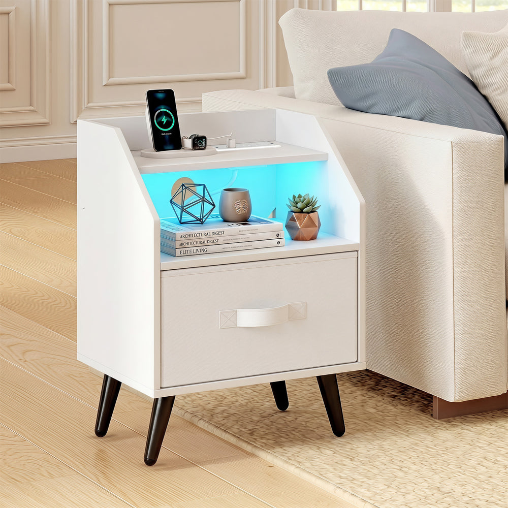 Nightstand in white with LED lights, fabric drawer, and open shelf for organized storage and device charging.