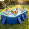 Children and a dog enjoy splashing in the navy non-inflatable swimming pool, perfect for outdoor fun and relaxation.