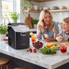 Nugget ice maker in black on a kitchen countertop, producing ice while a family enjoys ice cream together.