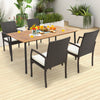 Four-piece patio wicker dining armchair set with soft zippered cushions, ideal for backyard or poolside dining.