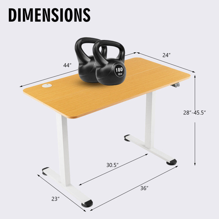 Electric standing computer desk with bamboo surface, adjustable height, and built-in cable grommet for tidy workspace.