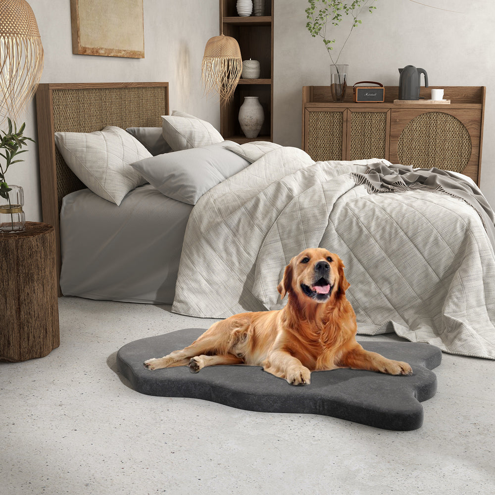 Orthopedic dog bed in gray with memory foam support, perfect for large dogs, placed beside a bed in a cozy bedroom.