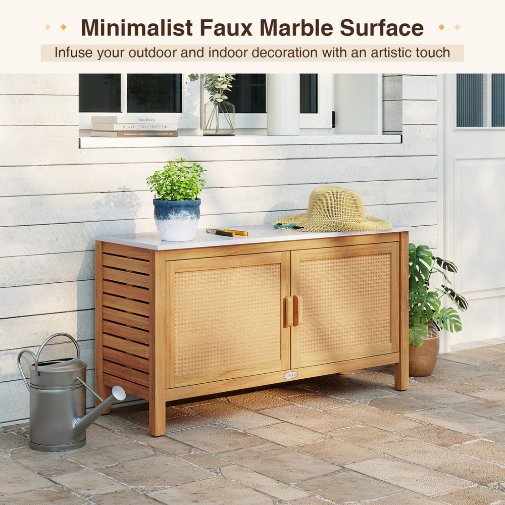 Outdoor acacia wood storage cabinet with faux marble top, featuring rattan doors and spacious shelves for versatile use.
