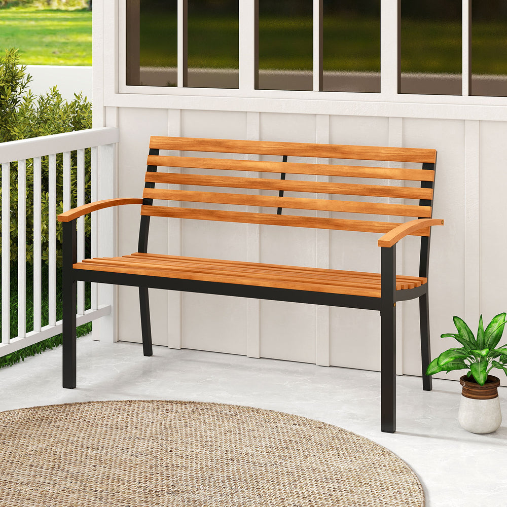 Acacia wood outdoor bench with backrest and armrests, featuring a sturdy metal frame, ideal for patio relaxation.