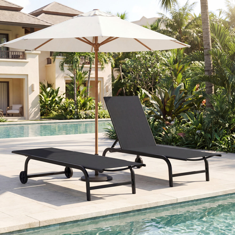 Black outdoor chaise lounge chair with wheels and metal frame, positioned by the poolside for relaxation.