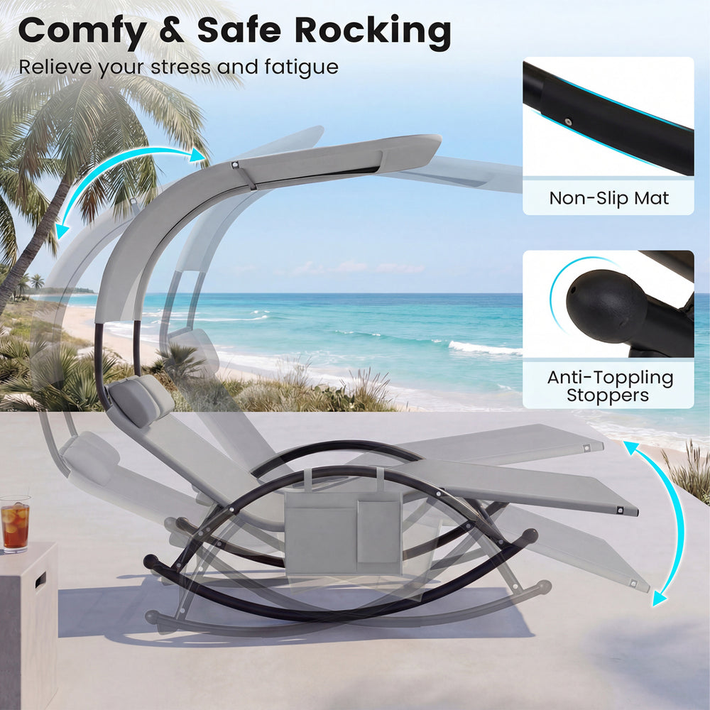 Outdoor dual rocker sunbed with gray fabric, large canopy, and detachable headrests for backyard relaxation.