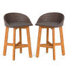 Set of 2 outdoor faux rattan bar chairs with acacia wood legs, ergonomic backrests, and cozy footrests for patio use.