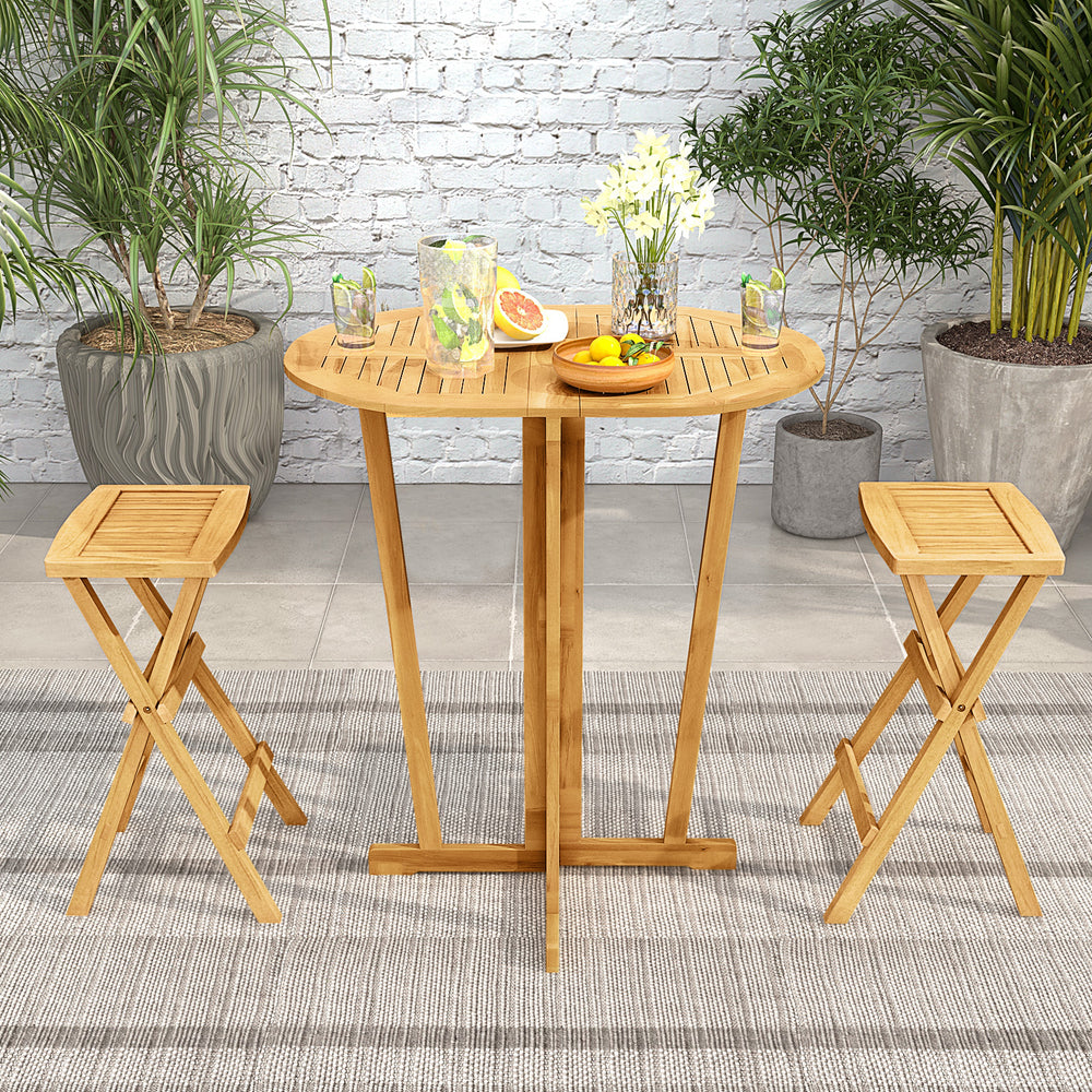 Folding bar table with oval teak wood top and sturdy cross base, ideal for pairing with 29"-33" bar height stools.
