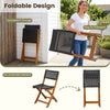 Folding outdoor chair made of brown PE rattan and acacia wood, ideal for easy transport and storage on patios or balconies.