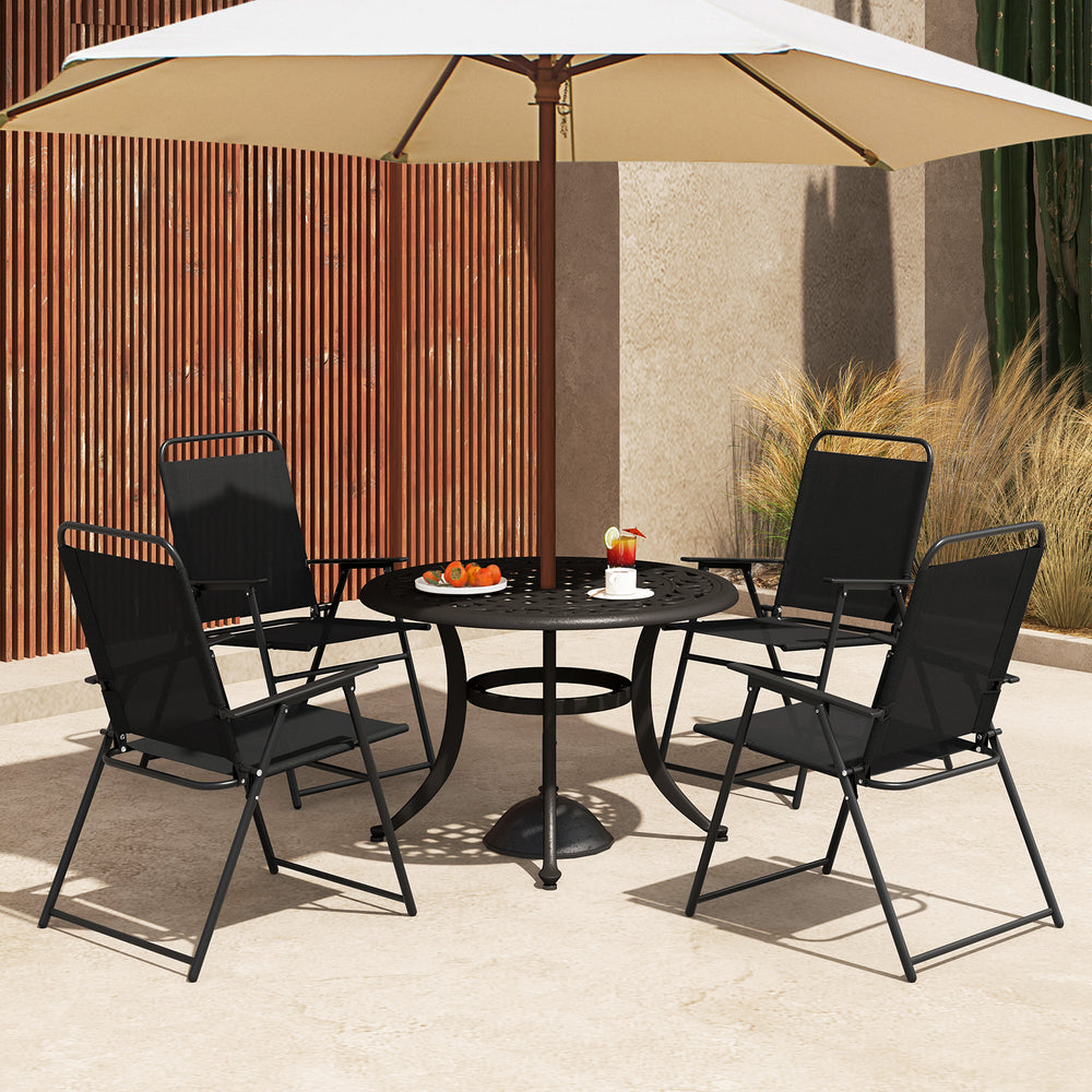 Set of 4 black outdoor folding sling chairs with armrests, arranged around a table under an umbrella for outdoor.