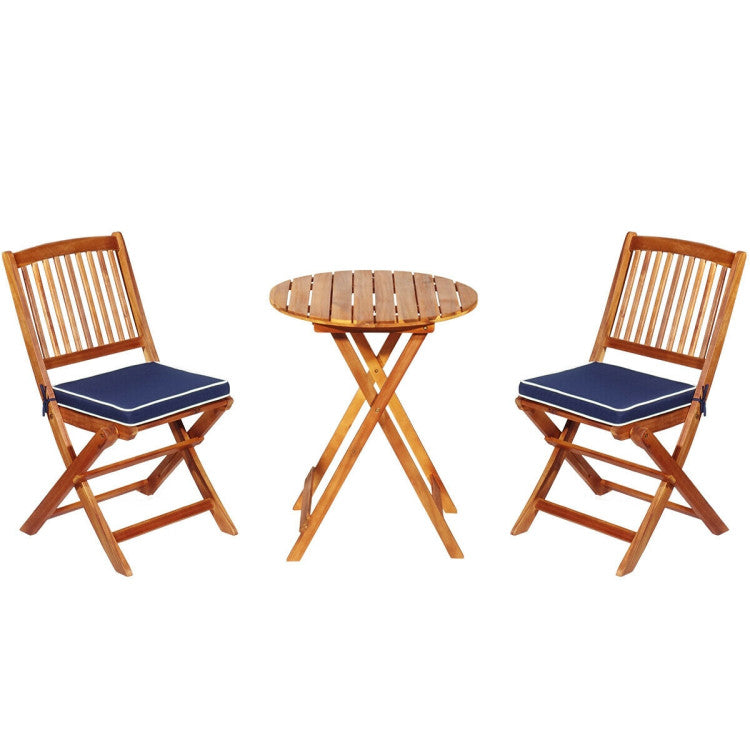 Bistro set featuring two stackable acacia wood chairs with cushions and a round folding table, perfect for outdoor.