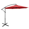 Red patio umbrella with a sturdy base, perfect for outdoor furniture sets and providing shade for patio relaxation.