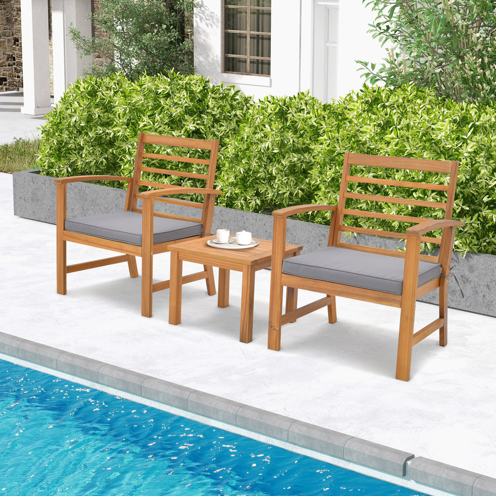 Outdoor furniture set featuring acacia wood chairs and a side table with gray cushions, perfect for poolside relaxation.