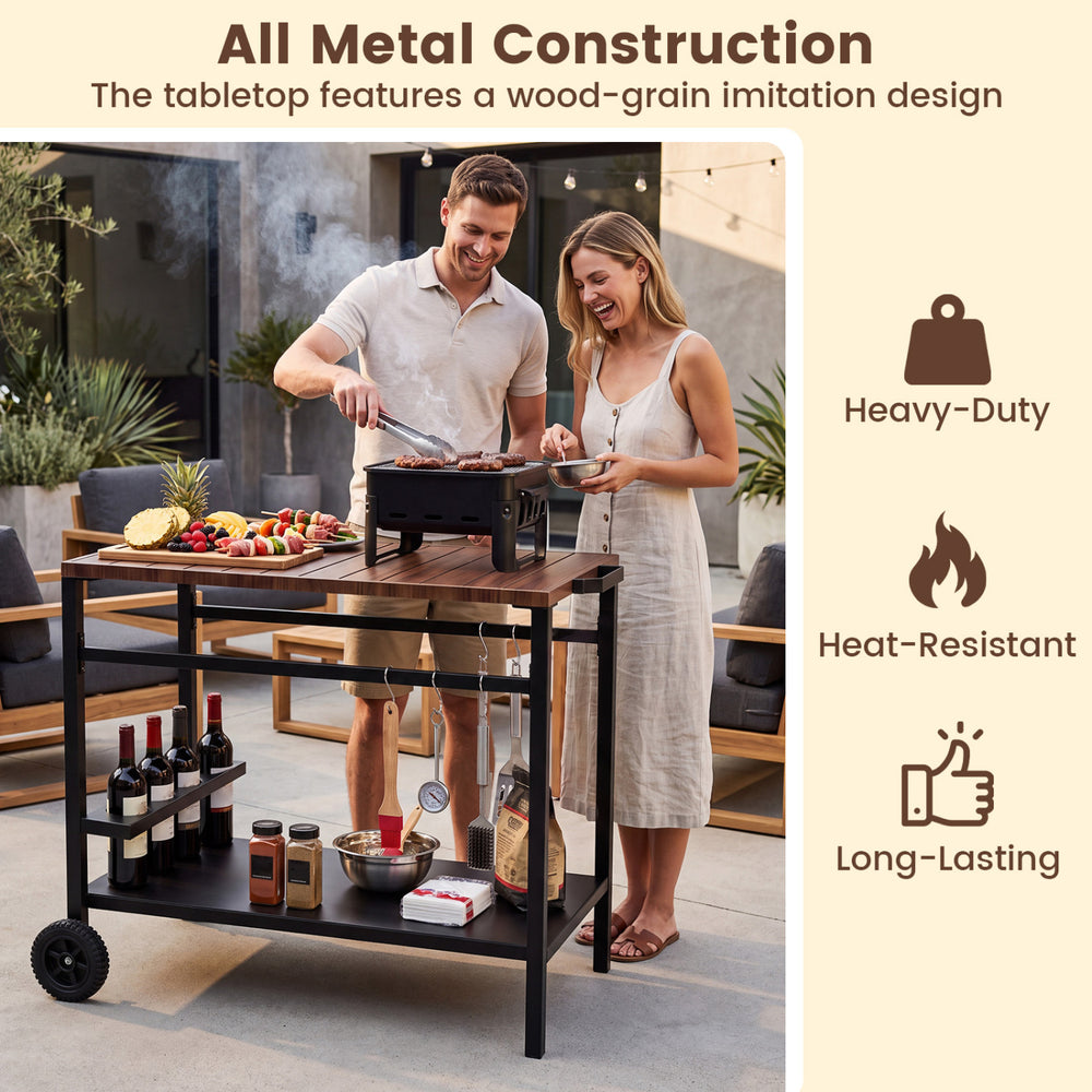 Outdoor grill cart with a stainless steel top, spice rack, and hooks, perfect for patio and garden cooking tasks.