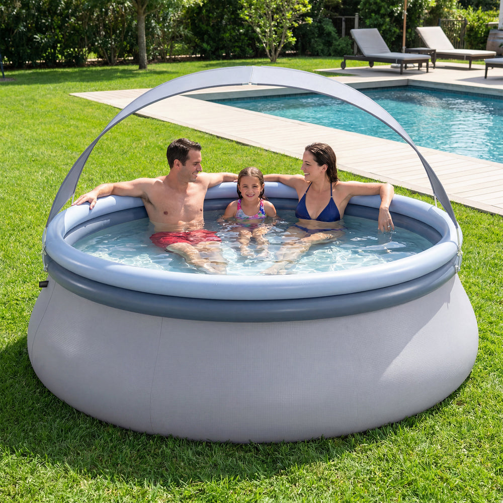 Outdoor inflatable pool with sunshade canopy, accommodating 4-6 adults, ideal for backyard summer fun and relaxation.
