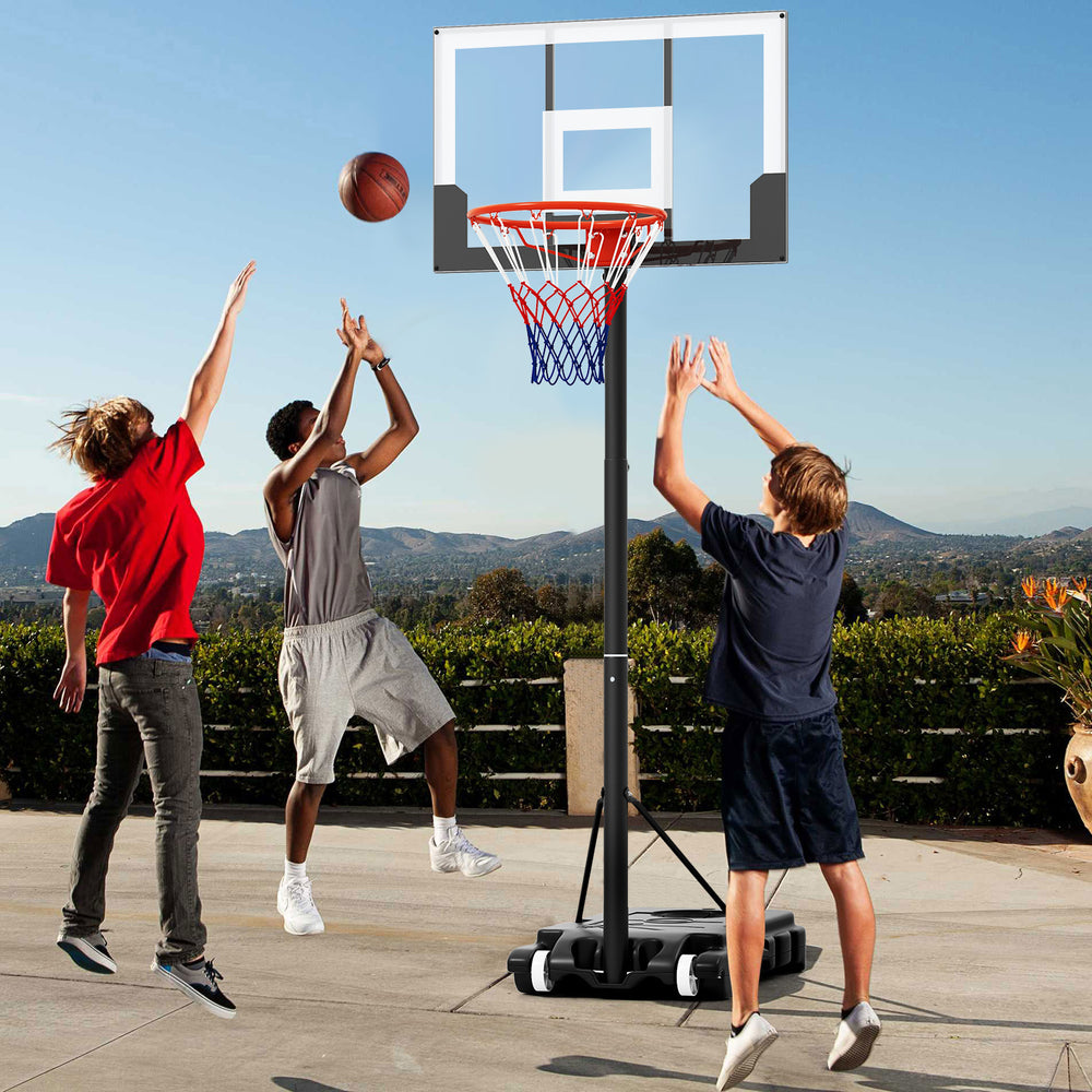 Kids playing basketball with a portable adjustable hoop system, featuring a shatterproof backboard and built-in wheels.