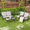 Two outdoor chairs with soft cushions and a coffee table in a lush backyard setting, ideal for outdoor lounging.