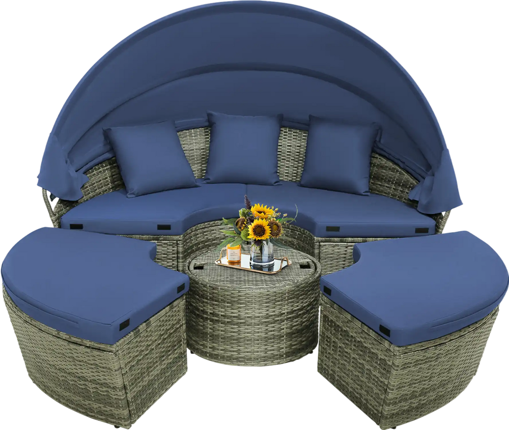 Round outdoor daybed with retractable canopy and navy cushions, made of gray PE wicker, ideal for backyard relaxation.
