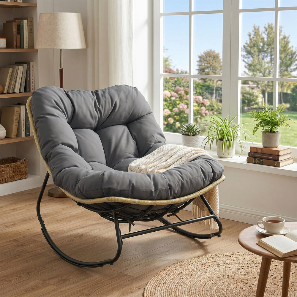 Gray outdoor Papasan rocking chair with thick cushioned seat, perfect for patio relaxation and comfort.