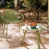 Green outdoor chair and coffee table from the Outdoor Paradise 7-Piece Patio Relaxation Set, perfect for garden.