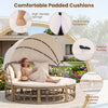 Outdoor patio daybed with retractable canopy, yellow wicker rattan, and comfortable padded cushions for garden relaxation.