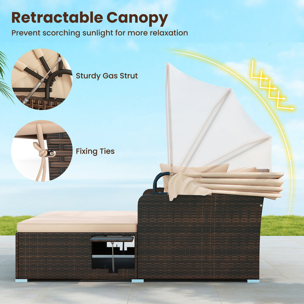 Outdoor patio rattan daybed with retractable canopy, beige cushions, and side tables for comfortable relaxation.