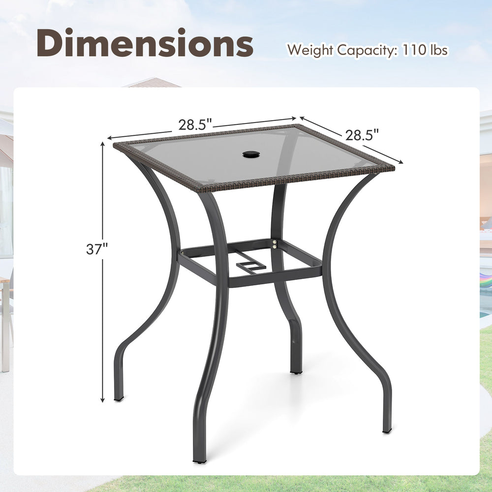 28.5-inch outdoor patio square table with rattan edging, glass top, and umbrella hole, ideal for indoor and outdoor use.
