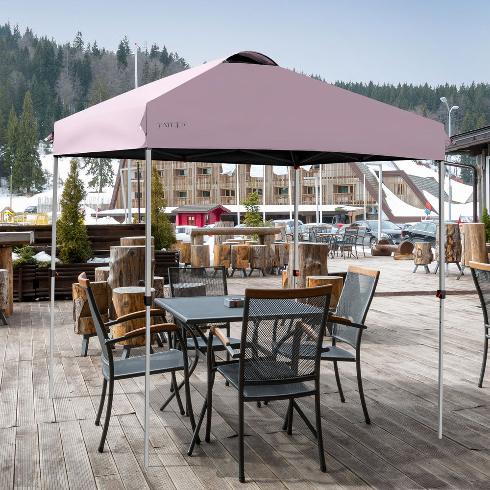 Pink 6.6 x 6.6 feet outdoor pop-up canopy tent with adjustable height, set up for outdoor dining and shade.