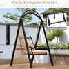 Outdoor porch swing with removable cushions, sturdy triangular structure, and side tables for garden relaxation.