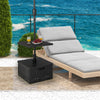 Fillable black umbrella base with table tray, designed for stability and convenience on outdoor patios.