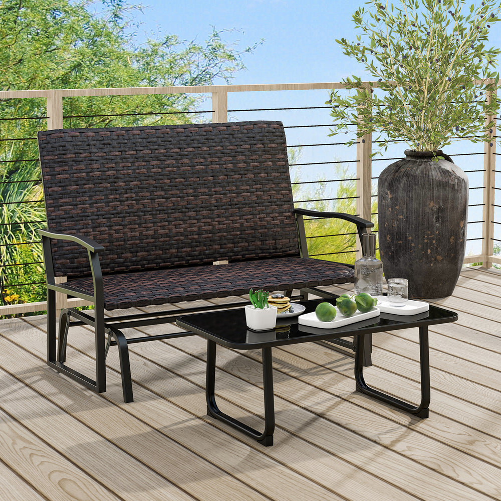 Two-person swing glider bench in brown with rattan surface and quick dry foam seat, perfect for outdoor relaxation.