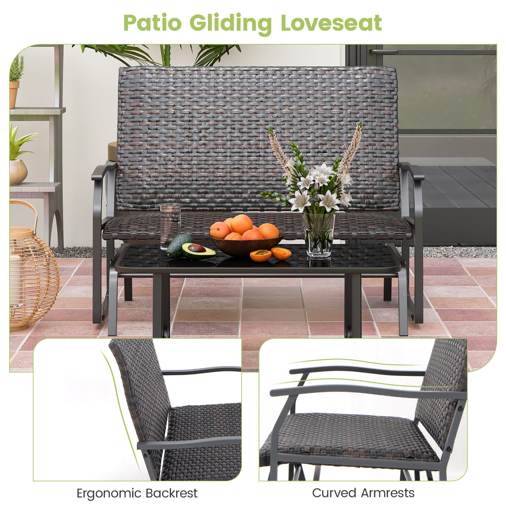 Patio gliding loveseat with brown rattan, ergonomic backrest, and curved armrests, perfect for outdoor relaxation.