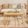 Teak wood coffee table with slatted tabletop, perfect for indoor or outdoor use, featuring a smooth, waterproof surface.