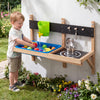 Outdoor wall-mounted mud kitchen for kids with sink, water faucet, and stovetop for imaginative play in the garden.