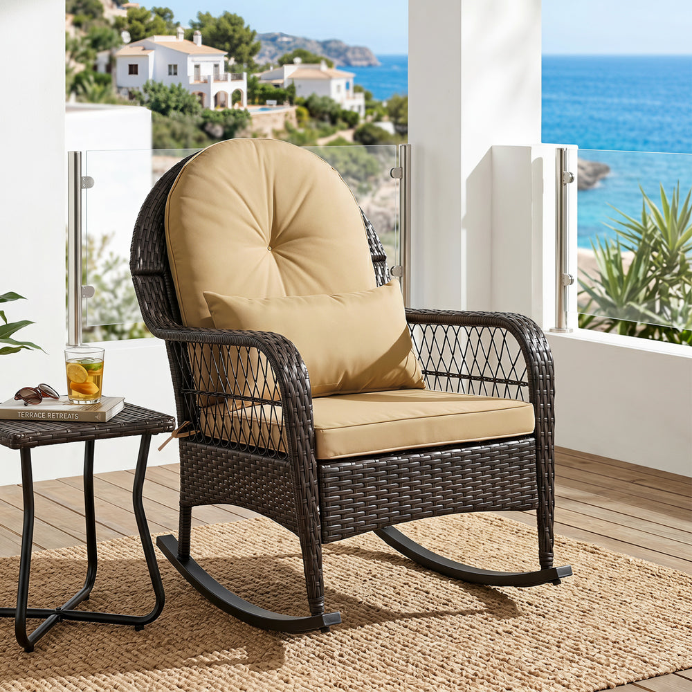 Brown outdoor wicker rocking chair with anti-tip stoppers, featuring thick cushions for comfort on a patio or porch.