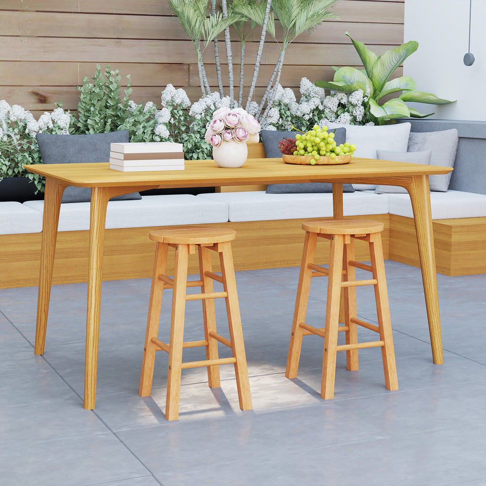 Set of two 24-inch outdoor wood bar stools with round seats and footrests, perfect for patio or garden use.