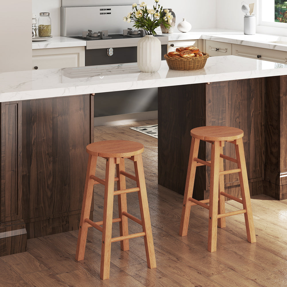 Set of 2 natural wood bar stools with round seats and footrests, perfect for outdoor patios or home kitchens.