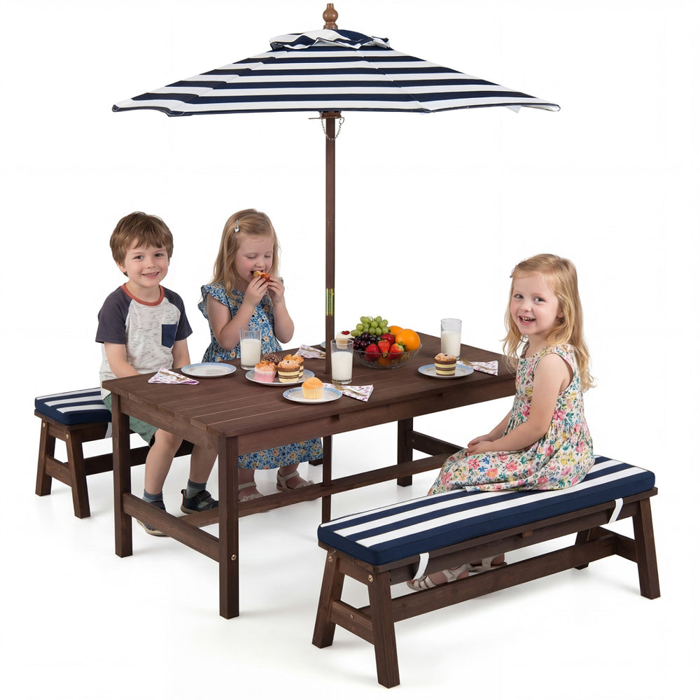 Kids enjoying snacks at the outdoor wooden picnic table with removable umbrella and blue cushions for fun dining.