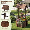 Outdoor wooden wishing well planter with a burnt-like wood finish, featuring a protective roof and decorative handle.