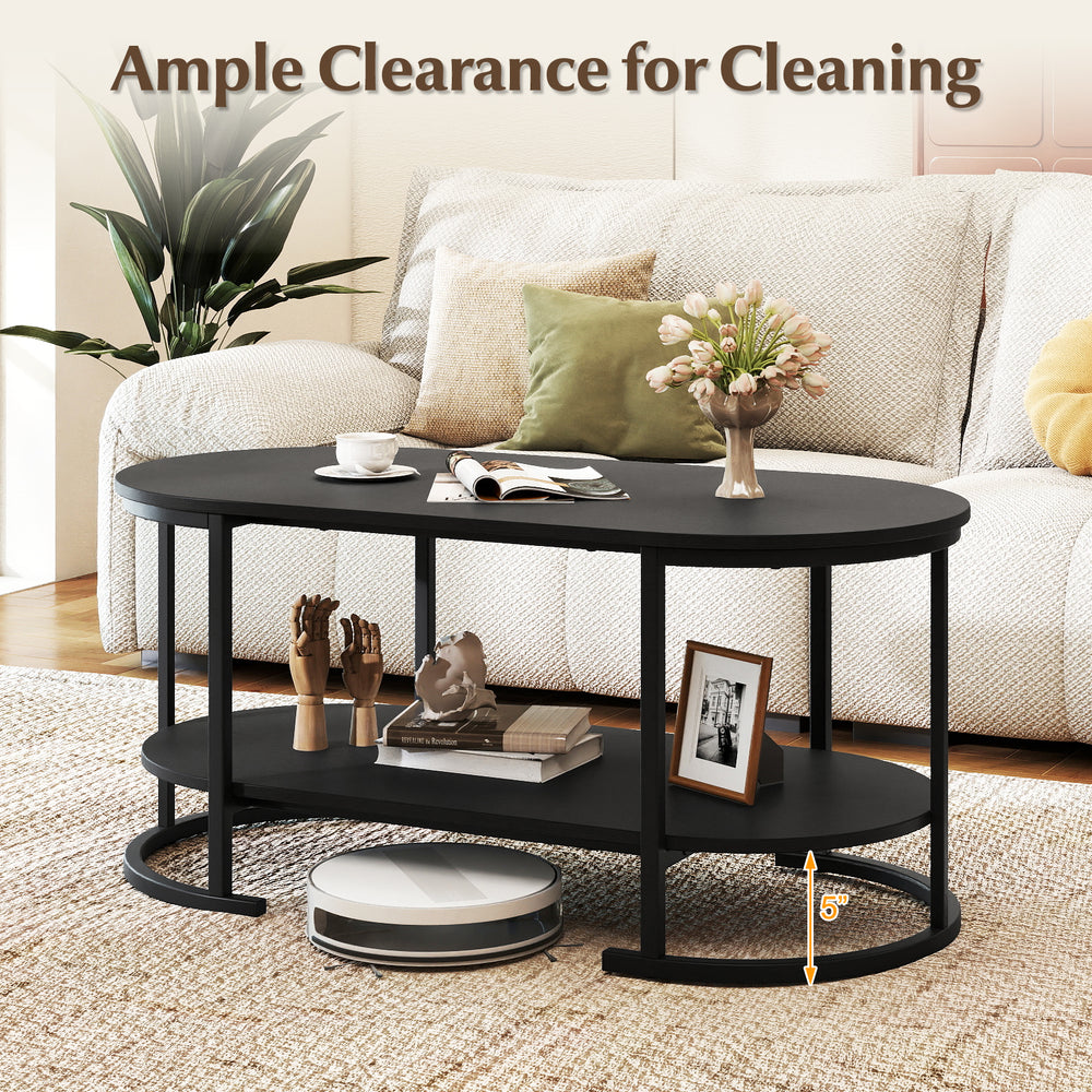 Oval black coffee table with 2-tier storage shelf and 5-inch clearance for easy robotic cleaning in a cozy living room.