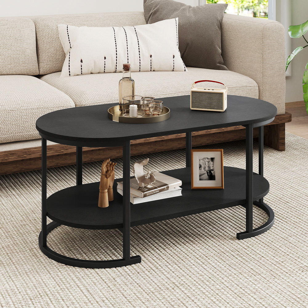 Oval coffee table with black finish, 2-tier storage shelf, and spacious tabletop, perfect for living room use.