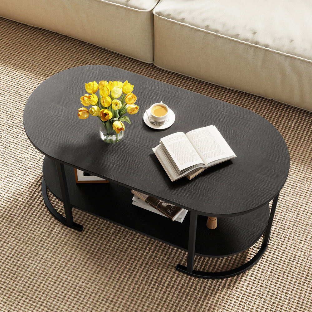 Oval coffee table with a black wooden finish, featuring a 2-tier shelf for storage and a spacious tabletop for.