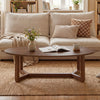 Oval coffee table with thickened walnut top and stable V-shaped base, perfect for snacks and decor in a cozy living.