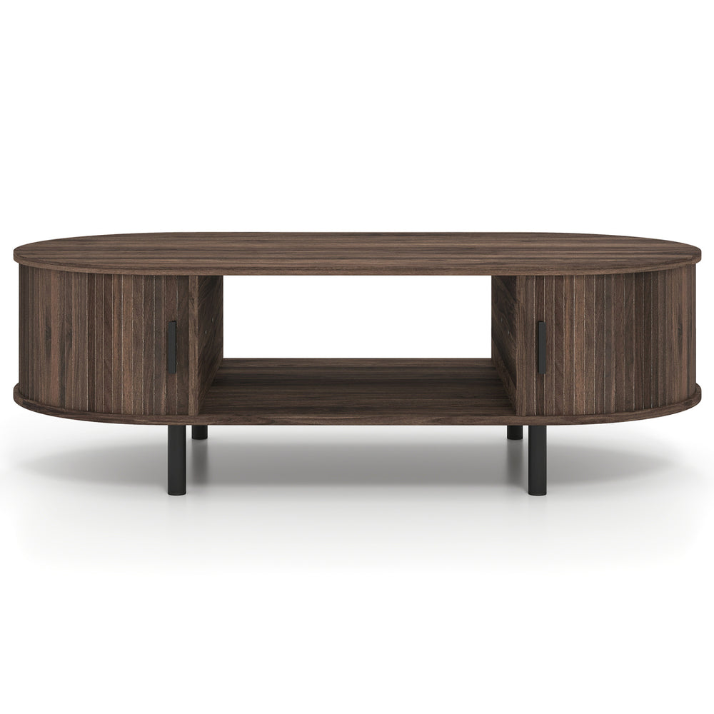 Oval coffee table with walnut finish, featuring dual side shelves and fluted door accents for stylish living room.
