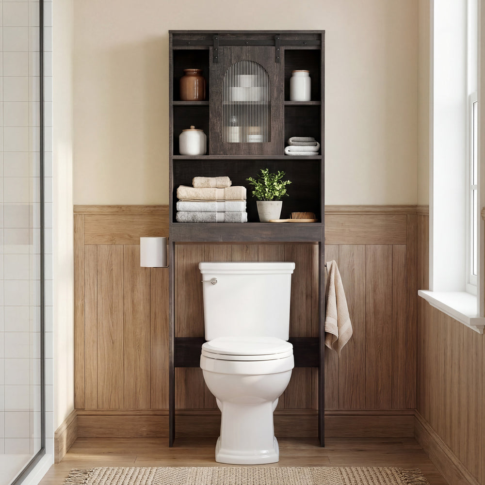 Over toilet storage cabinet in oak with sliding barn door and open shelves, perfect for organizing bathroom essentials.