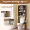 Over toilet storage cabinet in oak with sliding barn door, open shelves, and hooks for organized bathroom essentials.